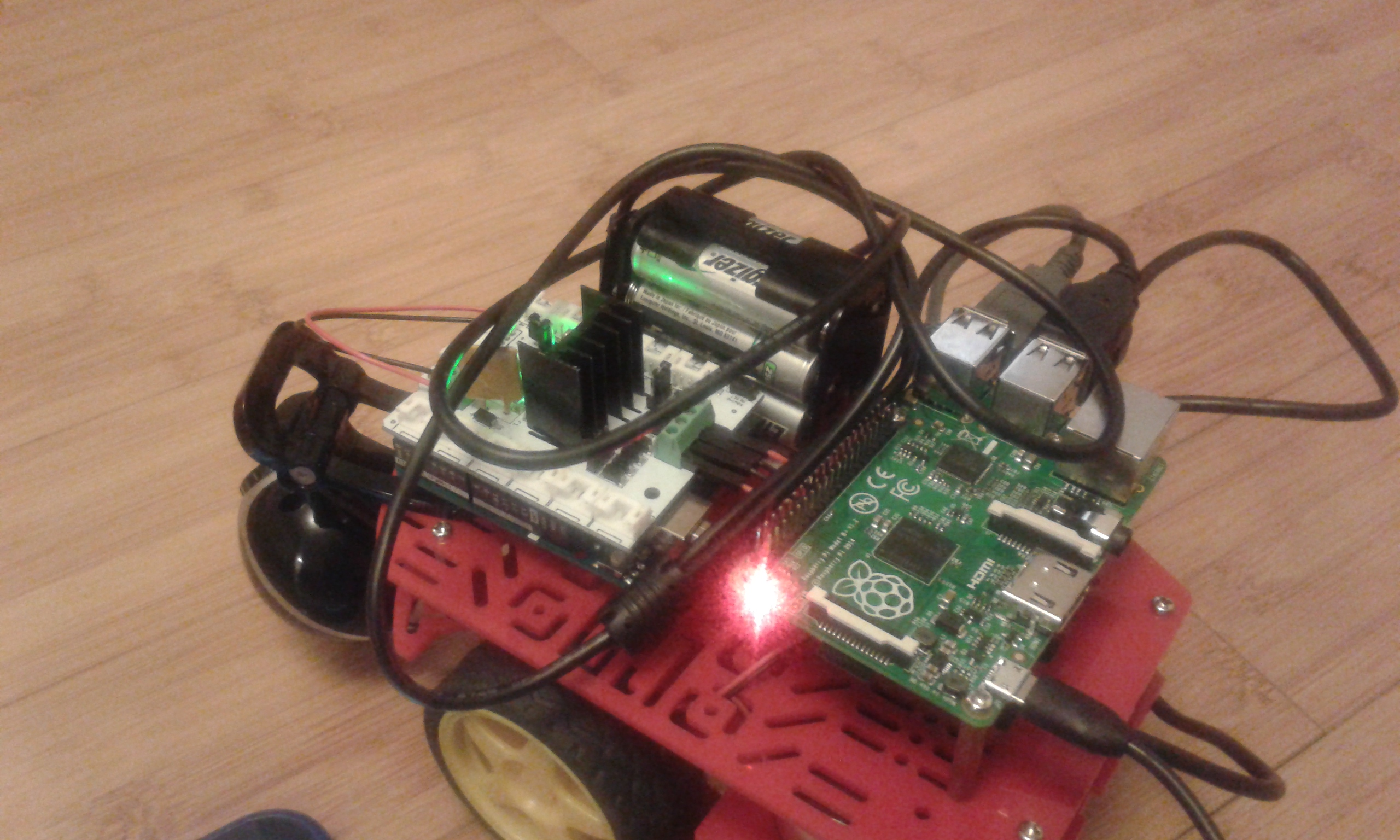 Another side view showing USB connectors (on the far side). The battery pack on top is used by the motor shield to provide power to the motors.